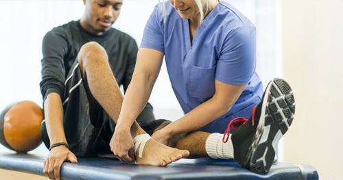 A man having his foot examined by a clinician.
