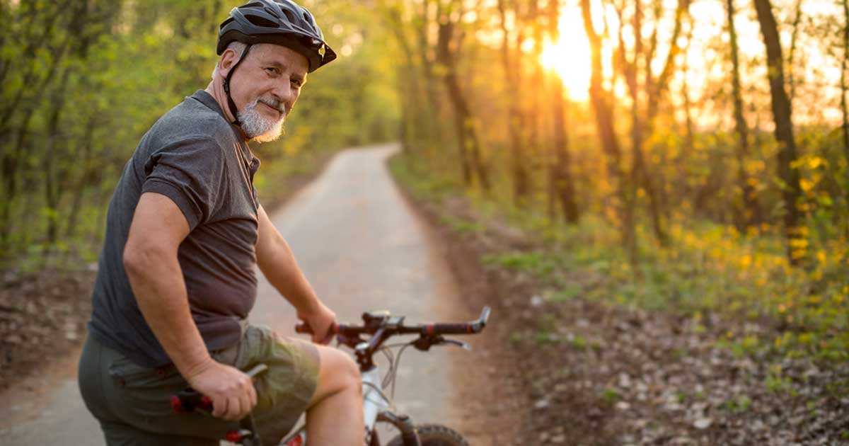 A man on a bicycle.